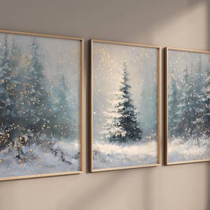 May include: Three framed winter landscape paintings. The artwork depicts snow-covered evergreen trees in a snowy forest. The color palette includes shades of blue, white, and gold, creating a serene and wintry atmosphere.