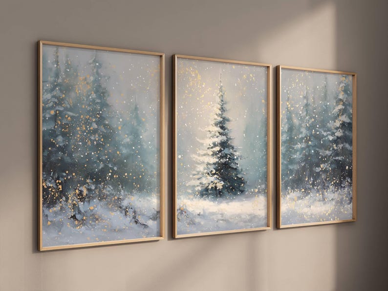 May include: Three framed winter landscape paintings. The artwork depicts snow-covered evergreen trees in a snowy forest. The color palette includes shades of blue, white, and gold, creating a serene and wintry atmosphere.
