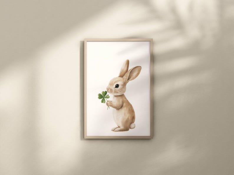 May include: A watercolor illustration of a brown rabbit holding a green four-leaf clover. The rabbit is standing on a white background.