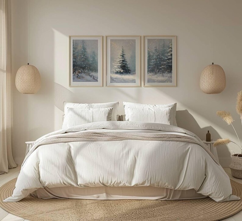 May include: A bedroom scene featuring a bed with white bedding, pillows, and a beige throw. Above the bed are three framed winter landscape paintings. Woven pendant lights hang on either side of the bed, and a round rug sits beneath.