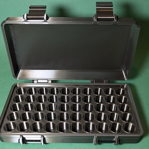 May include: A black plastic storage case with a hinged lid and 48 individual compartments. The case is open and the compartments are empty.
