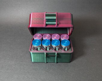 May include: A green and pink 3D printed case with a hinged lid, open to reveal eight small glass vials with blue and pink caps.