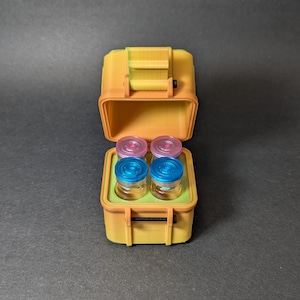 May include: A yellow, orange, and green plastic case with a latch. The case is open and contains four small glass vials with blue and pink lids.