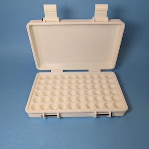 May include: White plastic storage case with a hinged lid and multiple compartments. The case is open and the compartments are empty.