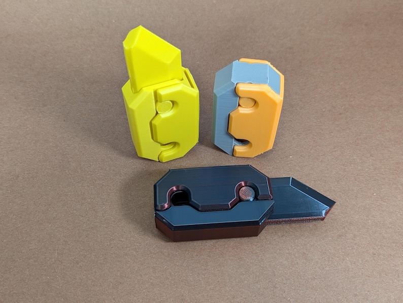 May include: Three different types of utility knives with different colored handles. The first knife has a yellow handle, the second knife has a gray and orange handle, and the third knife has a black handle.