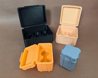 May include: Three different sized plastic storage boxes with lids. The largest box is black and has four compartments. The medium box is orange and has one compartment. The smallest box is light blue and has one compartment.