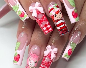 May include: Pink and white long, square-shaped acrylic nails with a strawberry shortcake theme. The nails are decorated with images of strawberry shortcake characters, strawberries, and gingham patterns. Some nails have 3D pink bows.