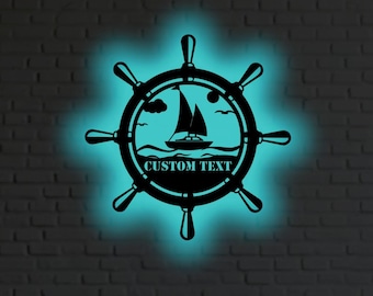 May include: Black metal wall art depicting a ship's wheel with a sailboat scene and a custom text area. The art has a glowing blue outline. The image shows a family in a living room.