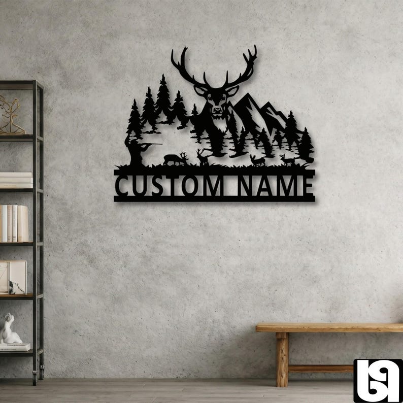 May include: Black metal wall art featuring a deer with large antlers, mountains, and trees. A hunter is aiming a rifle. The text "CUSTOM NAME" is displayed below the scene, suitable for personalized home decor.