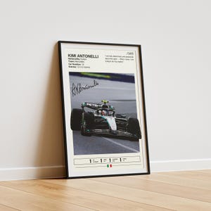 May include: Framed poster featuring Kimi Antonelli, an Italian race car driver. The poster includes a photo of a Formula 1 car, the driver's signature, and text with details like nationality, team, and car number. The poster is in a black frame.
