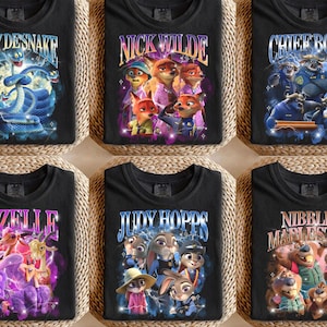 Puede incluir: Seis camisetas negras con gr&aacute;ficos coloridos que presentan personajes y texto de la pel&iacute;cula animada "Zootr&oacute;polis". Las camisetas muestran nombres como "Gary Desnake", "Nick Wilde" y "Chief Bogo" en fuentes estilizadas, con ilustraciones vibrantes.