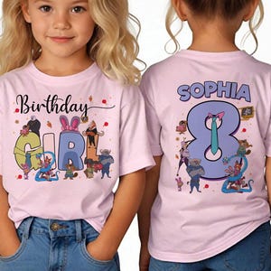 May include: Pink short-sleeved t-shirts with the text "Birthday Girl" and "Sophia 8" printed on them. The front of the shirt has a colorful graphic with cartoon characters. The back of the shirt has the name "Sophia" and the number "8".