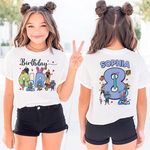 K&ouml;nnte beinhalten: Wei&szlig;es T-Shirt mit dem Text "Birthday Girl" und der Zahl "8" auf der Vorder- und R&uuml;ckseite. Das vordere Design enth&auml;lt bunte Cartoon-Figuren. Auf der R&uuml;ckseite des Shirts steht der Name "Sophia" &uuml;ber der Zahl.