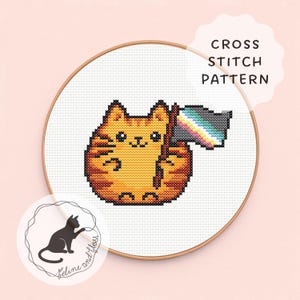 May include: A cross stitch pattern in a wooden hoop featuring an orange tabby cat holding a flag with horizontal stripes of grey, white, and a rainbow gradient. The text CROSS STITCH PATTERN is printed in the upper right corner of the image.