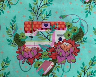 May include: A light turquoise fabric featuring a repeating pattern of sewing machines with orange polka dots, a purple heart, and green leaves. The design includes large red and purple flowers, small orange starbursts, and pink electrical cords.