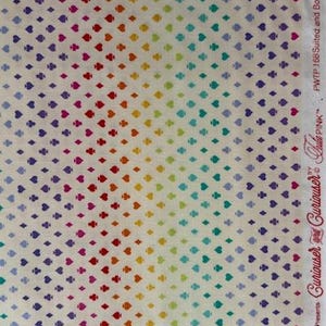 Op de afbeelding: Een witte stof met een herhalend patroon van kleine speelkaartsymbolen, waaronder harten, ruiten, klaveren en schoppen, in een regenboogverloop. De zelfkant toont de tekst "Curiouser and Curiouser by Tula Pink" en "PWTP 168 Suited and Booted".