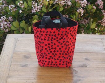 Dog Accessory Tote in a Black Pawprint on Red Print