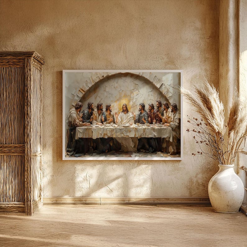 May include: A framed artwork depicting the Last Supper, with Jesus and his disciples seated at a table. The painting has a textured, three-dimensional effect, with a warm, neutral color palette. The artwork is displayed on a beige wall.