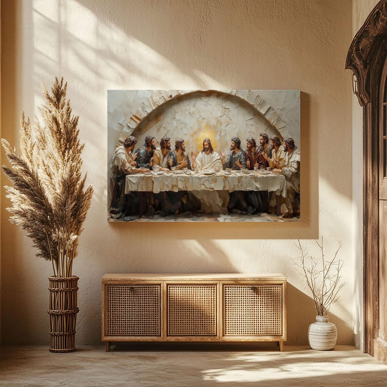 May include: A framed canvas print of "The Last Supper" hangs above a wooden cabinet. The artwork depicts Jesus and his disciples at a table, rendered in a textured, painterly style. The room features neutral tones and natural light.