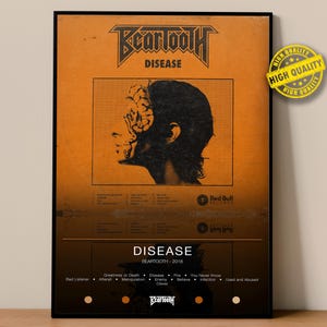 May include: A framed poster with the word "Beartooth" at the top, and "Disease" below it. The poster has an orange background with a black and white image of a person's profile. The poster also has the words "Red Bull Records" and "High Quality".