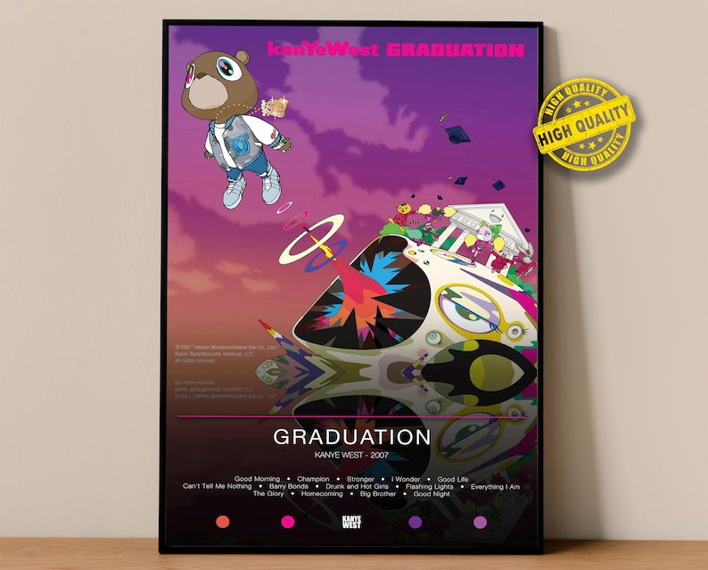 May include: A framed poster featuring the album art for Kanye West's "Graduation" album. The artwork depicts a bear mascot in a blue outfit floating above a colorful, abstract structure. The poster includes the album title and artist's name.