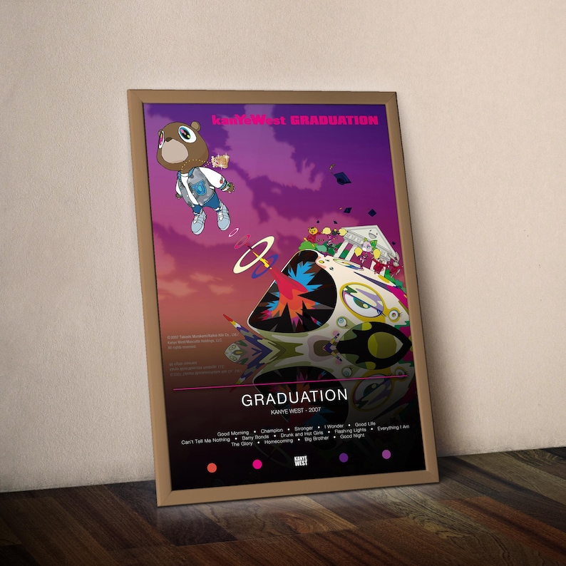 May include: A framed poster featuring the album art for Kanye West's "Graduation" album. The artwork includes a cartoon bear in a jacket and sneakers, a spaceship, and a purple and orange sky. The album title and tracklist are also visible.