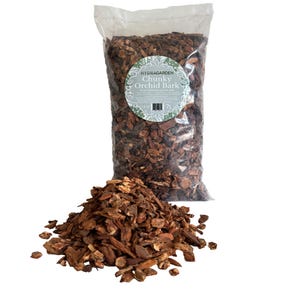 May include: A clear plastic bag filled with chunky orchid bark, with a pile of bark in front. The bag has a round label that reads "Hydragarden Chunky Orchid Bark". The bag contains 24 quarts and 7L of bark.