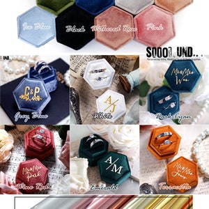 May include: Hexagon shaped velvet ring boxes in various colors, including mauve, grey, sky blue, tiffany blue, olives, royal blue, silver, blush, ice blue, black, withered rose, pink, grey blue, white, dark cyan, wine red, emerald, and terracotta. The boxes are shown with rings inside. The image also shows a close-up of four different colored rolls of metallic paper: silver, rose gold, champagne gold, and royal gold.