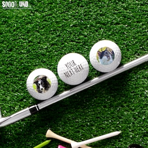 May include: Three white golf balls with personalized images. The first ball has a photo of a cat, the second ball has a photo of a dog, and the third ball has the text "YOUR NEXT HERE".