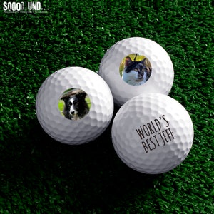 May include: Three white golf balls with personalized images. One ball has a black and white dog, one has a black and white cat, and one has the text "WORLD'S BEST JEFF".