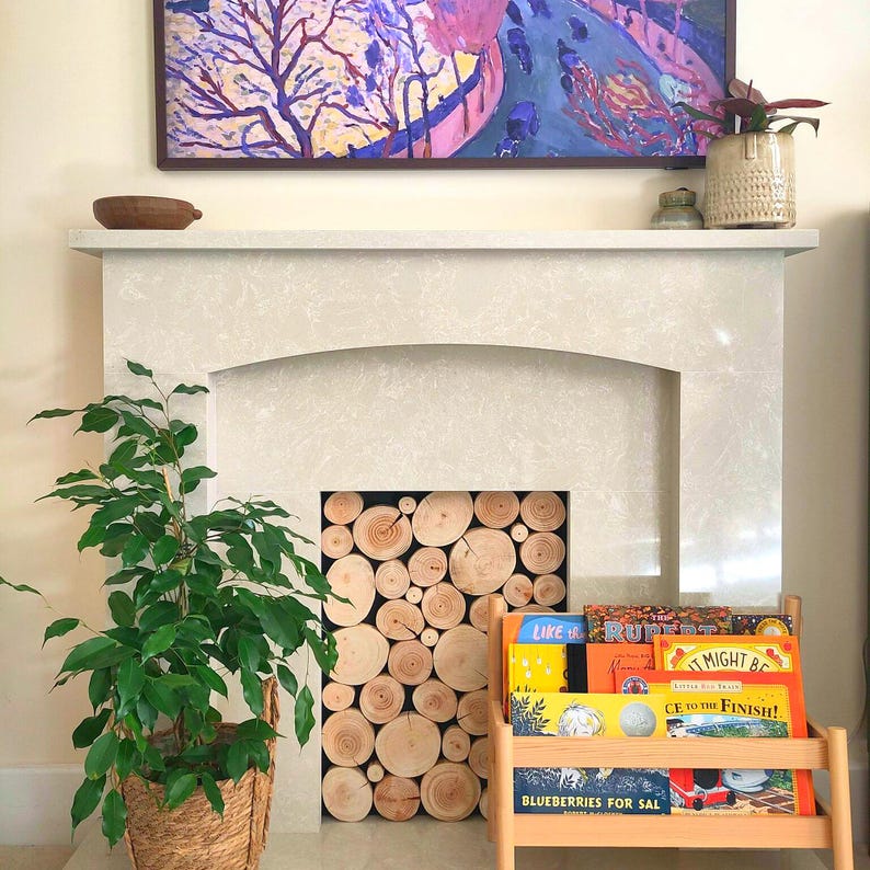 Log wall tiles from The Log Basket have been used to fill a fire surround to look like a stack of logs are being stored in the recess, instead of leaving it dark, dusty and empty. This is an easy way to add the warmth of natural wood to your home decor and looks great in the space, where the depth is too shallow for regular length logs. Ideal for any interior space the log tiles are clean and fully dry, ideal for permanent display.