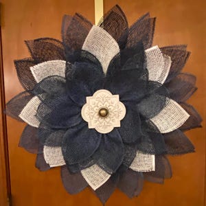 Poly Burlap Flower Wreath with Navy and Cream Petals and a cream wooden center with a gold knob.