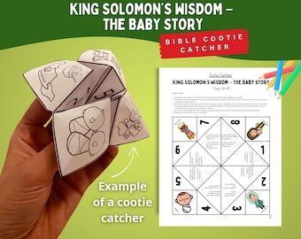 May include: A white paper cootie catcher with black line art illustrations and text, held in a hand. The text on the cootie catcher reads "KING SOLOMON'S WISDOM - THE BABY STORY". A printed page with instructions and a numbered diagram is also visible.