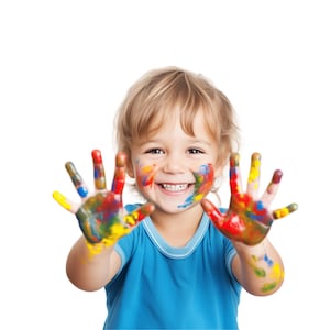 May include: A young child with colourful paint on their hands and face smiles at the camera.