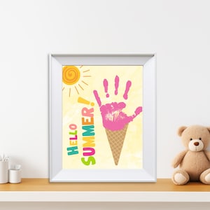 May include: A framed print featuring a yellow sun, the words "Hello Summer!" in colourful letters, and a pink handprint shaped like an ice cream cone.