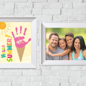 May include: Two white picture frames on a white brick wall. The frame on the left has a colourful illustration of an ice cream cone with the text "Hello Summer!" The frame on the right has a photo of a family of four smiling at the camera.