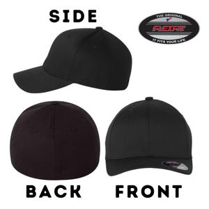 May include: Black baseball cap with a curved brim. The cap has a Flexfit logo on the front and the words "The Original Flexfit It Fits Your Life" on the back.