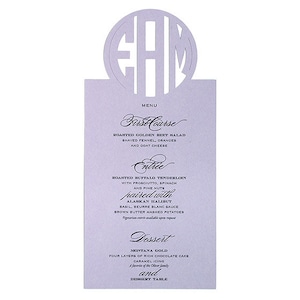 May include: A lavender menu card with a cut-out monogram of the letters "EHM". The menu lists the courses: "First Course", "Entree", and "Dessert".