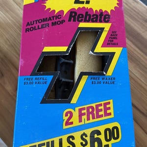 May include: A blue and yellow box with the words "mop rite" and "$2.00 Rebate" on it. The box advertises an automatic roller mop with two free refills for a total value of $6.00.