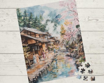 May include: A jigsaw puzzle depicting a Japanese village scene in watercolour, with traditional buildings, a river, and figures in kimonos. The puzzle includes the text "252, 520 & 1014 Piece Puzzle".