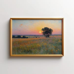 May include: A framed landscape painting depicting a grassy field with scattered yellow wildflowers under a sunset sky. A single dark tree stands on the right side of the horizon, while the sun appears as a bright yellow orb near the centre.