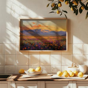 May include: A framed landscape painting depicts a field of colorful wildflowers under a sunset sky. The artwork features a wooden frame and is displayed on a tiled wall. The scene includes mountains and a vibrant display of orange, purple, and yellow flowers.