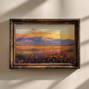May include: A framed landscape painting depicting a vibrant field of wildflowers in shades of orange, purple, and yellow, set against a backdrop of mountains and a sunset sky. The ornate, dark brown frame adds a classic touch to the artwork.