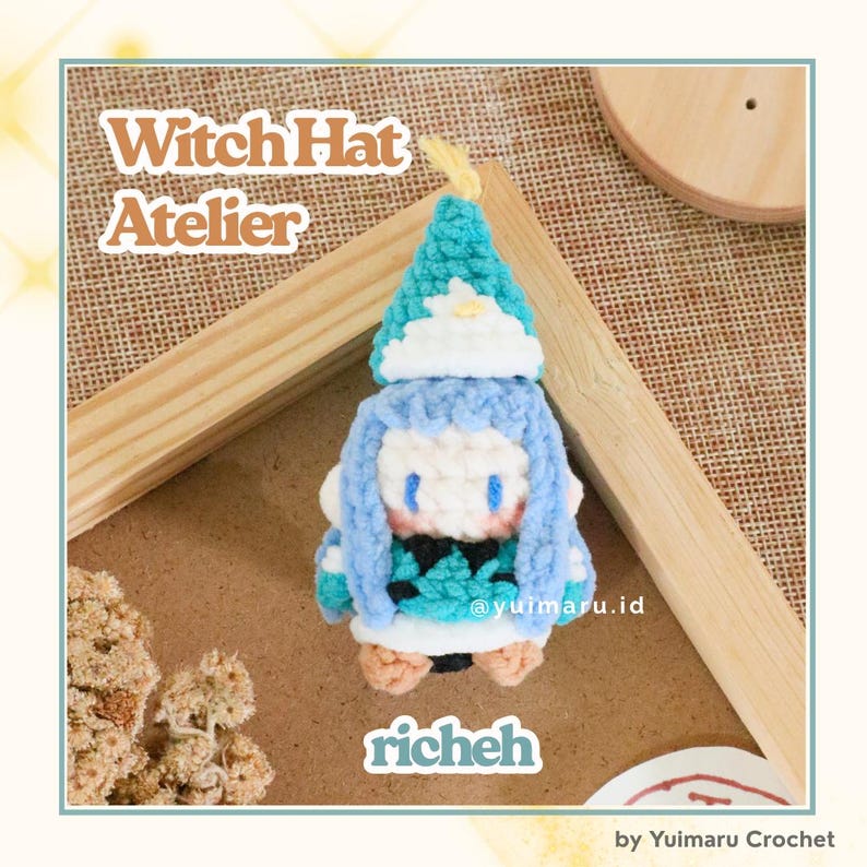 May include: A small crochet figure of a character wearing a pointed teal and white witch hat, light blue hair, and a teal patterned outfit. The text Witch Hat Atelier and richeh are visible. The figure is crafted with yarn in shades of teal, white, and tan.