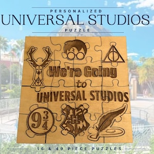 May include: A wooden puzzle with laser-etched designs and text. The puzzle features iconic symbols and the phrase "We're Going to Universal Studios." The puzzle is available in 16 and 49-piece options.