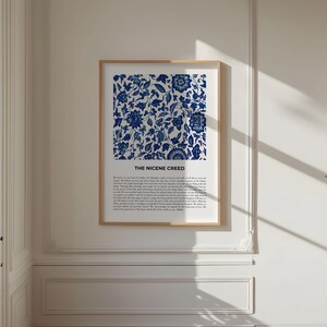 May include: A framed print with a blue and white floral pattern and the text "The Nicene Creed" below the image. The print is hanging on a white wall.