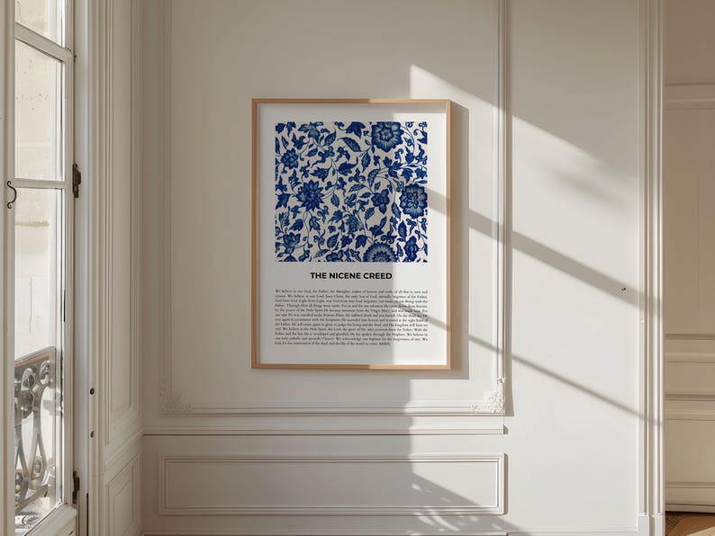 May include: A framed print with a blue and white floral pattern and the text "The Nicene Creed" below the image. The print is hanging on a white wall.