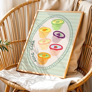 May include: A framed print featuring colorful illustrations of fruit jellies in individual cups. The artwork is set against a light green background with the words "Very Jelly" in a whimsical font. The frame is made of light-colored wood.