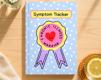 May include: A light blue notebook with white polka dots featuring a yellow rectangular label with the text Symptom Tracker and a central graphic of a pink award ribbon with a red smiling heart and the text Chronic Illness Warrior.