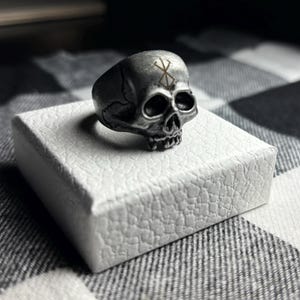 steel skull ring with berserk brand of sacrifice.